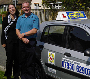 Driving instructors Ele and Richard by an Ipswich School of Motoring car